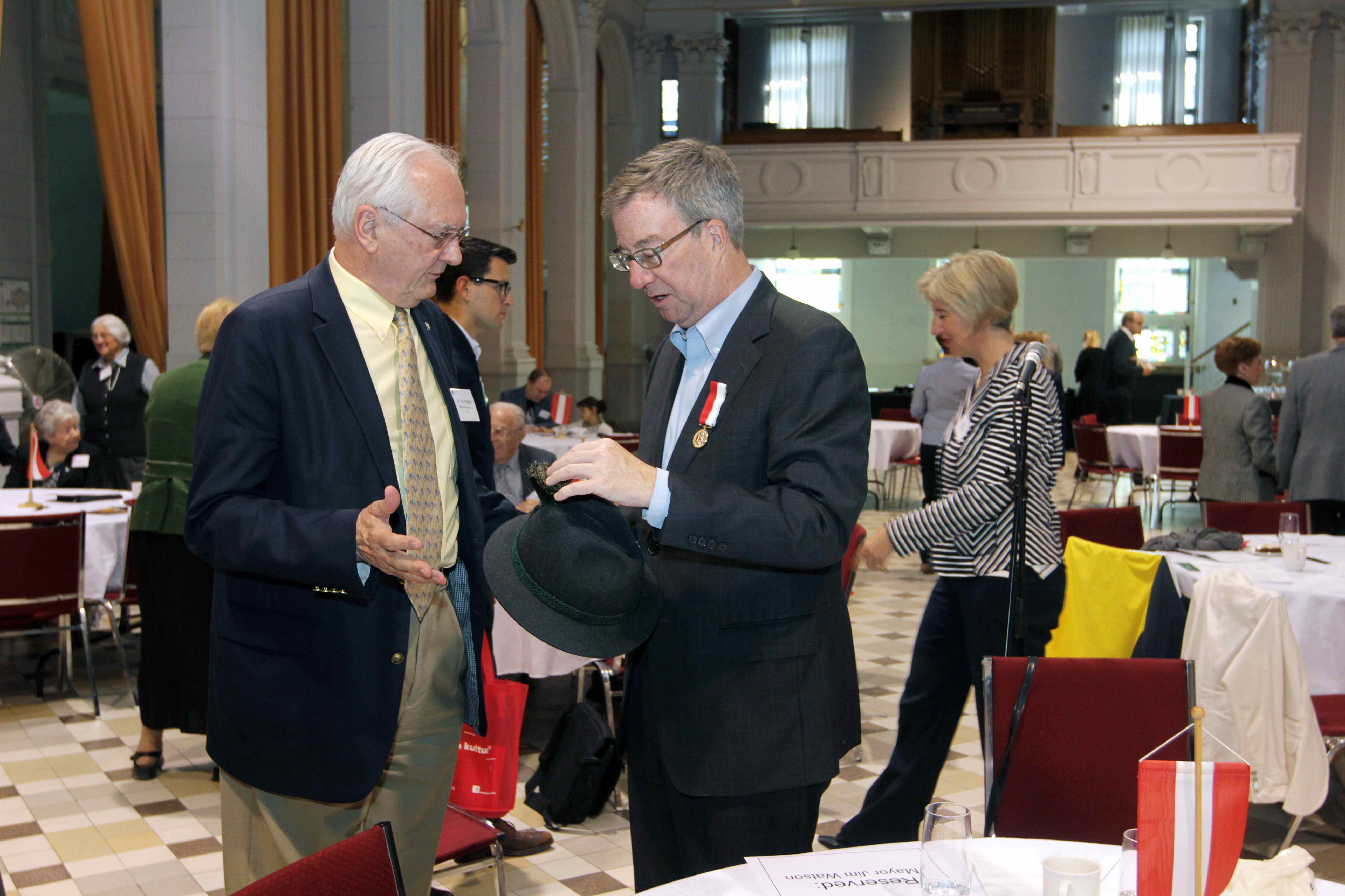 Dr. Wirth and Mayor Watson discuss the Austrian hat